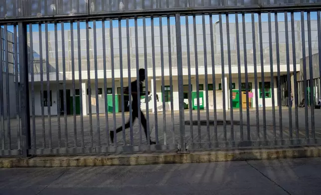 A detainee runs in an open area of the Ponte Galeria center, one of the facilities created in Italy to hold migrants ahead of their repatriation, as they are considered ineligible for refugee status or international protection, in Rome, Tuesday, March 19, 2024. (AP Photo/Andrew Medichini)