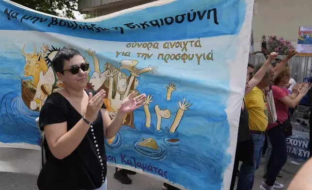 Protesters react after a court's decision as the banner reads "Justice shouldn't sink. Open borders for refugees" in Kalamata, southwestern Greece, on Tuesday, May 21, 2024. A Greek judge dismissed charges against nine Egyptian men accused of causing a shipwreck that killed hundreds of migrants last year and sent shockwaves through the European Union's border protection and asylum operations, after a prosecutor told the court Greece lacked jurisdiction. (AP Photo/Thanassis Stavrakis)