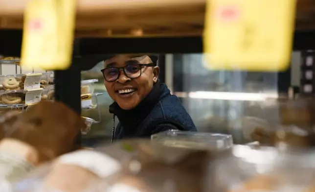 Ella Anthony smiles during an interview in the supermarket where she works, in Rome, Tuesday, March 26, 2024. Knowing that she faced a possible prison term since Nigeria criminalizes same-sex relationships, Anthony fled with her partner to Libya in 2014 and then Italy, where they both won asylum. Their claim? That they had a well-founded fear of anti-LGBTQ+ persecution back home. (AP Photo/Alessandra Tarantino)