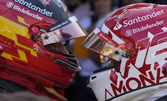 Ferrari driver Charles Leclerc of Monaco, right, is congratulated by Ferrari driver Carlos Sainz of Spain after the qualifying session ahead of the Formula One Monaco Grand Prix at the Monaco racetrack, in Monaco, Saturday, May 25, 2024. (AP Photo/Luca Bruno)
