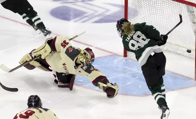 Boston forward Susanna Tapani (88) scores against Montreal goalie Ann-Renee Desbiens (35) during overtime of a PWHL playoff hockey game Tuesday, May 14, 2024, in Lowell, Mass. (AP Photo/Mark Stockwell)