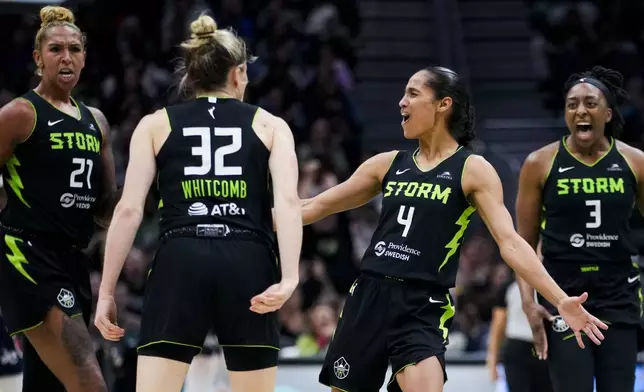 Seattle Storm center Mercedes Russell (21), guard Sami Whitcomb (32), guard Skylar Diggins-Smith (4) and forward Nneka Ogwumike (3) react as they lead during the second half of a WNBA basketball game against the Washington Mystics, Saturday, May 25, 2024, in Seattle. The Storm won 101-69. (AP Photo/Lindsey Wasson)