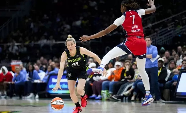 Seattle Storm guard Sami Whitcomb looks to go under the defense of Washington Mystics guard Ariel Atkins (7) during the first half of a WNBA basketball game Saturday, May 25, 2024, in Seattle. (AP Photo/Lindsey Wasson)