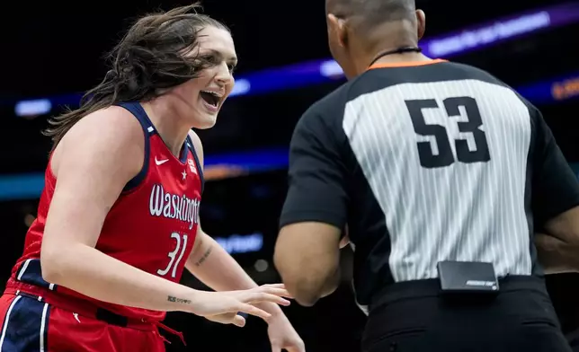 Washington Mystics center Stefanie Dolson, left, argues a call with referee Jeffrey Smith (53) during the first half of a WNBA basketball game against the Seattle Storm, Saturday, May 25, 2024, in Seattle. (AP Photo/Lindsey Wasson)