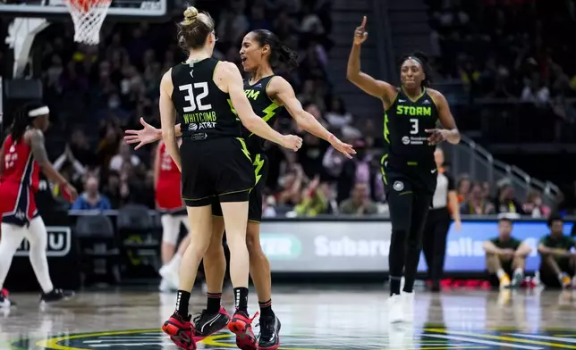 Seattle Storm guard Sami Whitcomb (32) celebrates with guard Skylar Diggins-Smith, second from left, after Diggins-Smith assisted forward Nneka Ogwumike (3) on a basket against the Washington Mystics during the second half of a WNBA basketball game Saturday, May 25, 2024, in Seattle. The Storm won 101-69. (AP Photo/Lindsey Wasson)