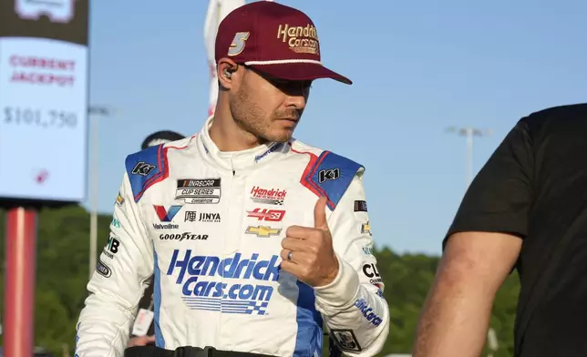 Kyle Larson gives a thumbs-up after arriving for the NASCAR All-Star auto race at North Wilkesboro Speedway in North Wilkesboro, N.C., Sunday, May 19, 2024. (AP Photo/Chuck Burton)