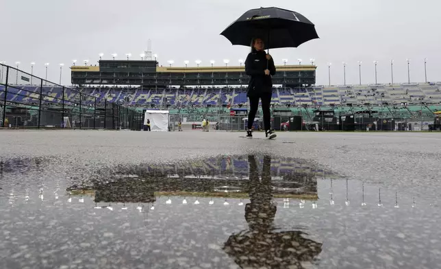 Water pools near the garage area as rain delays a NASCAR Cup Series auto race at Kansas Speedway in Kansas City, Kan., Sunday, May 5, 2024. (AP Photo/Colin E. Braley)
