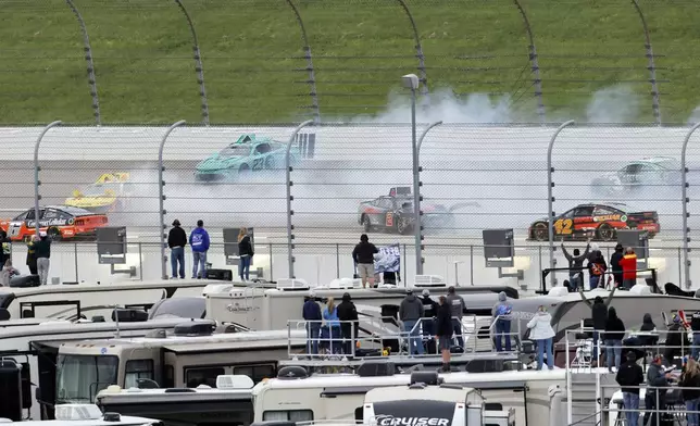 Multiple racers wreck coming out of Turn 3 during a NASCAR Cup Series auto race at Kansas Speedway in Kansas City, Kan., Sunday, May 5, 2024. (AP Photo/Colin E. Braley)
