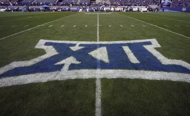 FILE - The logo for the Big 12 Conference has been applied to the field for an NCAA college football game between Sam Houston State and BYU on Saturday, Sept. 2, 2023, in Provo, Utah. The NCAA and the nation's five biggest conferences have agreed to pay nearly $2.8 billion to settle a host of antitrust claims,a monumental decision that sets the stage for a groundbreaking revenue-sharing model that could start directing millions of dollars directly to athletes as soon as the 2025 fall semester. (AP Photo/Rick Bowmer, File)