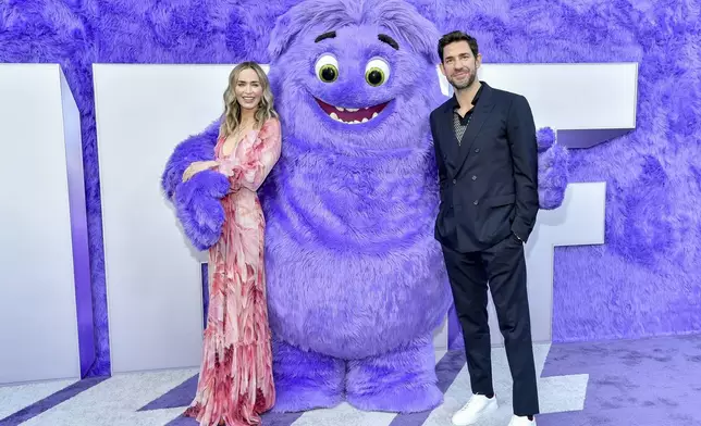 Emily Blunt, left, and John Krasinski pose with the character "Blue" at the premiere of Paramount Pictures' "IF" at the SVA Theatre on Monday, May 13, 2024, in New York. (Photo by Evan Agostini/Invision/AP)