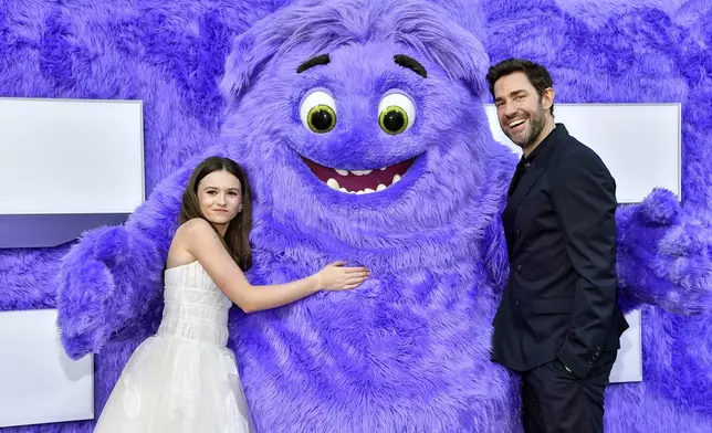 Cailey Fleming, left, and John Krasinski pose with the character "Blue" at the premiere of Paramount Pictures' "IF" at the SVA Theatre on Monday, May 13, 2024, in New York. (Photo by Evan Agostini/Invision/AP)