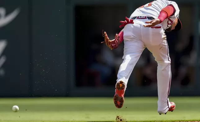 Atlanta Braves shortstop Orlando Arcia (11) can't get the ball hit by Washington Nationals Jesse Winker (6) in the first inning of a baseball game, Monday, May 27, 2024, in Atlanta. (AP Photo/Mike Stewart)