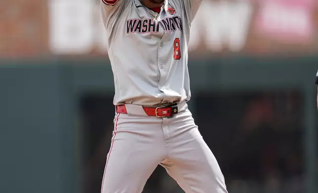 Washington Nationals outfielder Eddie Rosario (8) celebrates hitting an RBI double in the first inning of a baseball game against the Atlanta Braves, Monday, May 27, 2024, in Atlanta. (AP Photo/Mike Stewart)