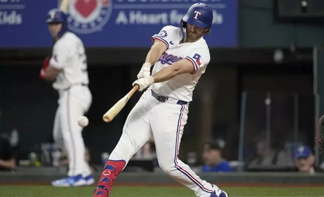 Texas Rangers' Josh Smith connects for a double in the eighth inning of a baseball game against the Washington Nationals in Arlington, Texas, Thursday, May 2, 2024. (AP Photo/Tony Gutierrez)