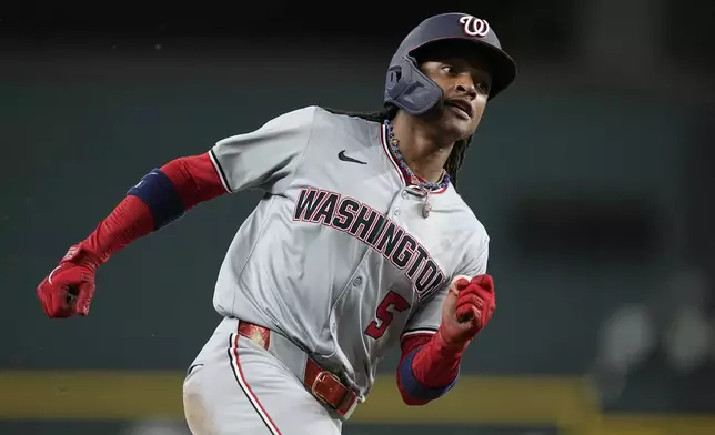 Washington Nationals' CJ Abrams sprints home to score on a single by Washington Nationals' Luis Garcia Jr. in the first inning of a baseball game against the Texas Rangers in Arlington, Texas, Tuesday, April 30, 2024. (AP Photo/Tony Gutierrez)