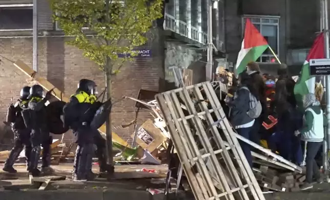 In this image taken from video Police arrests some 125 activists as they broke up a pro-Palestinian demonstration camp at the University of Amsterdam in Amsterdam, the Netherlands, Tuesday, May 7, 2024, as protests that have roiled campuses in the United States spread into Europe. (AP Photo InterVision)