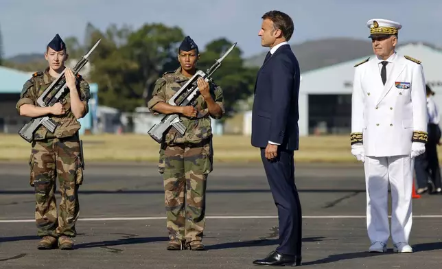 French President Emmanuel Macron stands alongside French High Commissioner to New Caledonia, Louis Le Franc, right, during the official welcome ceremony upon his arrival at Noumea ñ La Tontouta International airport, in Noumea, New Caledonia, Thursday, May 23, 2024. Macron has landed in riot-hit New Caledonia, having crossed the globe by plane from Paris in a high-profile show of support for the French Pacific archipelago wracked by deadly unrest and where indigenous people have long sought independence from France. (Ludovic Marin/Pool Photo via AP)