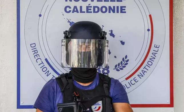 A policeman waits for the arrival of French President Emmanuel Macron at the central police station in Noumea, New Caledonia, Thursday, May 23, 2024. Macron has met with local officials in riot-hit New Caledonia, after crossing the globe in a high-profile show of support for the French Pacific archipelago gripped by deadly unrest.(Ludovic Marin/Pool Photo via AP)