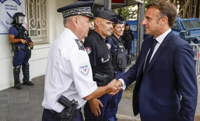 French President Emmanuel Macron visits the central police station in Noumea, New Caledonia, Thursday, May 23, 2024. Macron has met with local officials in riot-hit New Caledonia, after crossing the globe in a high-profile show of support for the French Pacific archipelago gripped by deadly unrest.(Ludovic Marin/Pool Photo via AP)