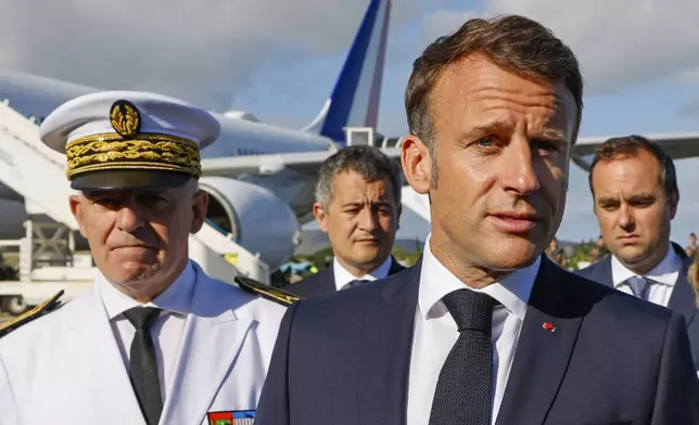 French President Emmanuel Macron speaks with the press upon arrival at Noumea ñ La Tontouta International airport, in Noumea, New Caledonia, Thursday, May 23, 2024. Macron has landed in riot-hit New Caledonia, having crossed the globe by plane from Paris in a high-profile show of support for the French Pacific archipelago wracked by deadly unrest and where indigenous people have long sought independence from France. (Ludovic Marin/Pool Photo via AP)