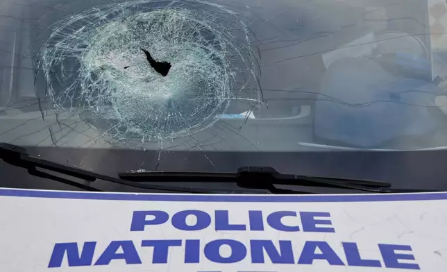 A police vehicle damaged during recent riots, during a visit by French President Emmanuel Macron at the central police station in Noumea, New Caledonia, Thursday, May 23, 2024. Macron has met with local officials in riot-hit New Caledonia, after crossing the globe in a high-profile show of support for the French Pacific archipelago gripped by deadly unrest.(Ludovic Marin/Pool Photo via AP)