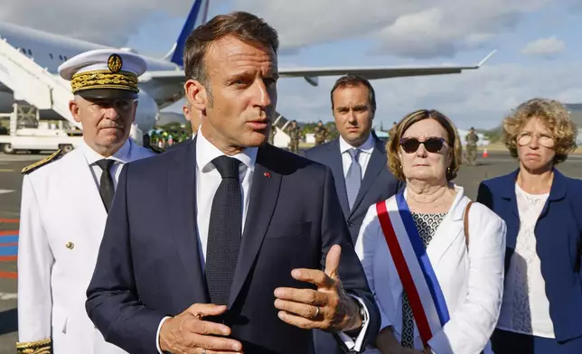 French President Emmanuel Macron gestures as he speaks with the press upon arrival at Noumea ñ La Tontouta International airport, in Noumea, New Caledonia, Thursday, May 23, 2024. Macron has landed in riot-hit New Caledonia, having crossed the globe by plane from Paris in a high-profile show of support for the French Pacific archipelago wracked by deadly unrest and where indigenous people have long sought independence from France. (Ludovic Marin/Pool Photo via AP)