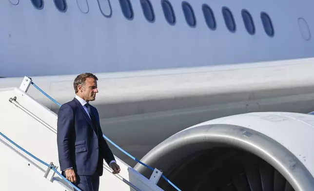 French President Emmanuel Macron steps off his plane on arrival at Noumea ñ La Tontouta International airport, in Noumea, New Caledonia, Thursday, May 23, 2024. Macron has landed in riot-hit New Caledonia, having crossed the globe by plane from Paris in a high-profile show of support for the French Pacific archipelago wracked by deadly unrest and where indigenous people have long sought independence from France. (Ludovic Marin/Pool Photo via AP)