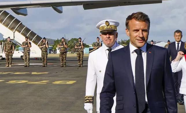 French President Emmanuel Macron prepares to speak with the press upon arrival at Noumea ñ La Tontouta International airport, in Noumea, New Caledonia, Thursday, May 23, 2024. Macron has landed in riot-hit New Caledonia, having crossed the globe by plane from Paris in a high-profile show of support for the French Pacific archipelago wracked by deadly unrest and where indigenous people have long sought independence from France. (Ludovic Marin/Pool Photo via AP)