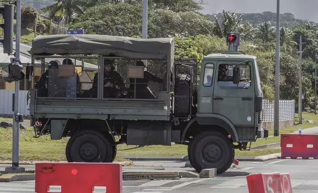 French gendarmes patrol the streets in Noumea, New Caledonia, Thursday May, 16, 2024. France has imposed a state of emergency in the French Pacific territory of New Caledonia. The measures imposed on Wednesday for at least 12 days boost security forces' powers to quell deadly unrest that has left four people dead, erupting after protests over voting reforms. (AP Photo/Cedric Jacquot)