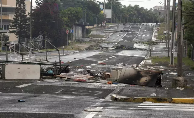 A street in Noumea, New Caledonia, is pictured after unrest, Wednesday May 15, 2024. France has imposed a state of emergency in the French Pacific territory of New Caledonia. The measures imposed on Wednesday for at least 12 days boost security forces' powers to quell deadly unrest that has left four people dead, erupting after protests over voting reforms. (AP Photo/Nicolas Job)