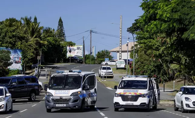 Municipal police vans patrol the streets in Noumea, New Caledonia, Thursday May, 16, 2024. France has imposed a state of emergency in the French Pacific territory of New Caledonia. The measures imposed on Wednesday for at least 12 days boost security forces' powers to quell deadly unrest that has left four people dead, erupting after protests over voting reforms. (AP Photo/Cedric Jacquot)