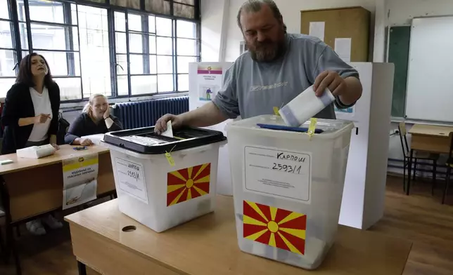 A man casts his ballots for the parliamentary election and the presidential runoff, at a polling station in Skopje, North Macedonia, on Wednesday, May 8, 2024. Voters in North Macedonia go to the polls Wednesday for a double election — parliamentary and presidential — following a campaign in which the country's aspirations to join the European Union have played a central role. (AP Photo/Boris Grdanoski)