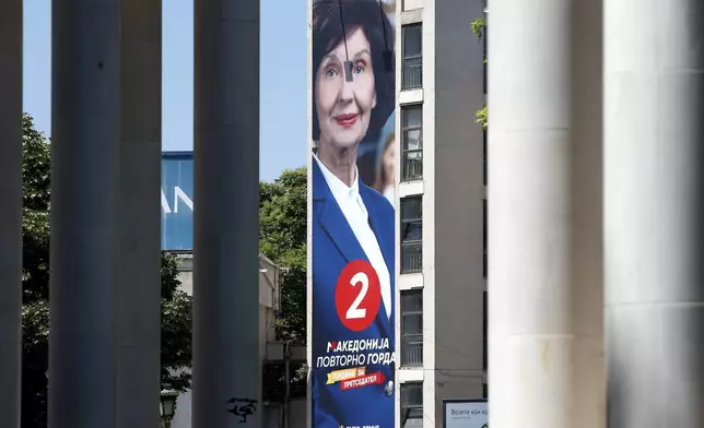 A giant poster of Gordana Siljanovska Davkova, the presidential candidate supported by the center-right main opposition VMRO-DPMNE coalition, hanging on a building in Skopje, North Macedonia, on Monday, May 6, 2024. Voters go to the polls on Wednesday in North Macedonia to cast ballots for parliamentary election and presidential runoff, for the second time in two weeks. (AP Photo/Boris Grdanoski)