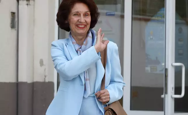 Gordana Siljanovska Davkova, presidential candidate backed by the opposition center-right VMRO-DPMNE party, waves as she leaves from a polling station in Skopje, North Macedonia, on Wednesday, May 8, 2024. Voters in North Macedonia were casting ballots on Wednesday in a parliamentary election and a presidential runoff dominated by issues including the country's path toward European Union membership, corruption and the economy. (AP Photo/Boris Grdanoski)