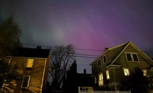 Northern lights shine over Portsmouth, N.H., Friday, May 10, 2024. (AP Photo/Caleb Jones)