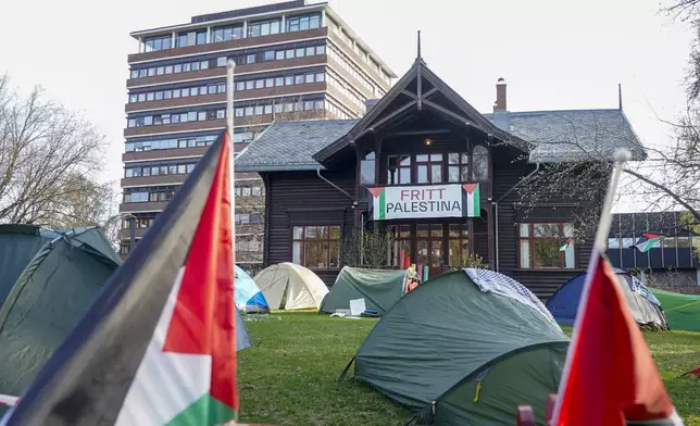 Students set up tents on the grounds of the University of Oslo, in protest against the war in Gaza, in Oslo, Thursday, May 2, 2024, replicating the nationwide campus demonstrations in the US. Sign on building in the background reads "Free Palestine". (Terje Pedersen/NTB Scanpix via AP)