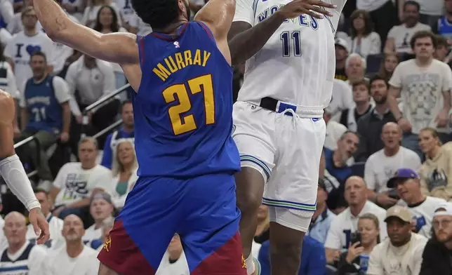 Minnesota Timberwolves center Naz Reid (11) shoots over Denver Nuggets guard Jamal Murray (27) during the second half of Game 6 of an NBA basketball second-round playoff series Thursday, May 16, 2024, in Minneapolis. (AP Photo/Abbie Parr)