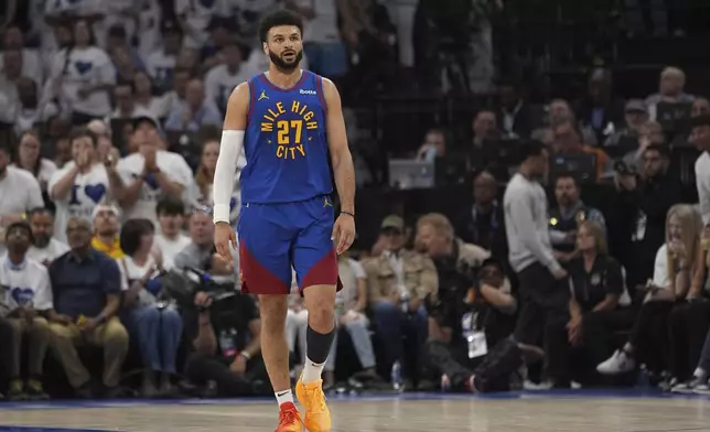 Denver Nuggets guard Jamal Murray walks on the court during the first half of Game 6 of the team's NBA basketball second-round playoff series against the Minnesota Timberwolves, Thursday, May 16, 2024, in Minneapolis. (AP Photo/Abbie Parr)