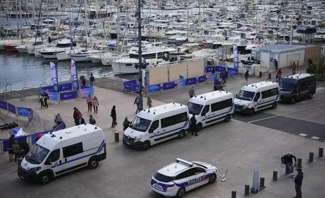 Police patrol before the arrival of the Olympic flame in the Old Port of Marseille in southern France, Tuesday, May 7, 2024. The Olympic torch will finally enter France when it reaches the southern seaport of Marseille on Wednesday. (AP Photo/Daniel Cole)
