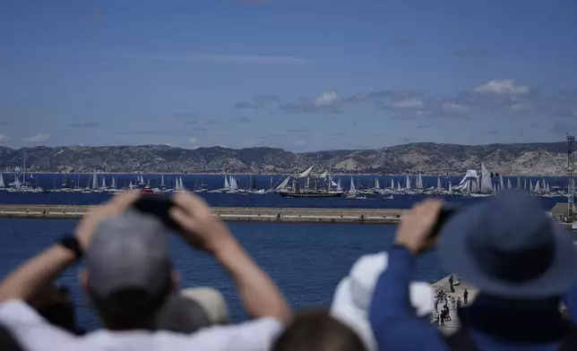 The Belem, the three-masted sailing ship which is carrying the Olympic flame, is accompanied by other boats approaching Marseille, southern France, Wednesday, May 8, 2024. After leaving Marseille, a vast relay route is undertaken before the torch odyssey ends on July 27 in Paris. The Paris 2024 Olympic Games will run from July 26 to Aug.11, 2024. (AP Photo/Thibault Camus)