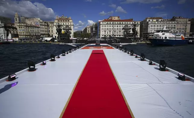 A red carpet is pictured before the arrival of the Olympic flame in the Old Port of Marseille in southern France, Tuesday, May 7, 2024. The Olympic torch will finally enter France when it reaches the southern seaport of Marseille on Wednesday. (AP Photo/Daniel Cole)