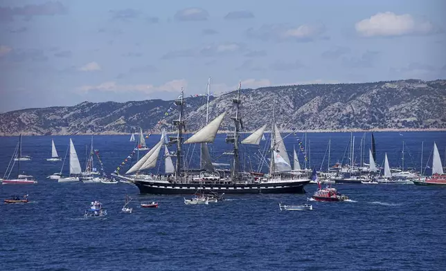 The Belem, the three-masted sailing ship bringing the Olympic flame from Greece, is escorted by other boats when approaching Marseille, southern France, Wednesday, May 8, 2024. After leaving Marseille, a vast relay route is undertaken before the torch odyssey ends on July 27 in Paris. The Paris 2024 Olympic Games will run from July 26 to Aug.11, 2024. (AP Photo/Laurent Cipriani)