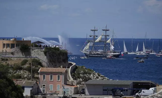 The Belem, the three-masted sailing ship which is carrying the Olympic flame, is accompanied by other boats approaching Marseille, southern France, Wednesday, May 8, 2024. After leaving Marseille, a vast relay route is undertaken before the torch odyssey ends on July 27 in Paris. The Paris 2024 Olympic Games will run from July 26 to Aug.11, 2024. (AP Photo/Thibault Camus)