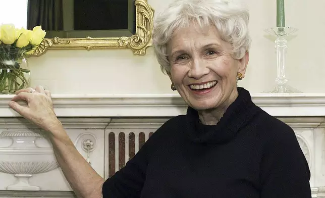 FILE - Canadian author Alice Munro poses for a photograph at the Canadian Consulate's residence in New York on Oct. 28, 2002. Munro, the Canadian literary giant who became one of the world’s most esteemed contemporary authors and one of history's most honored short story writers, has died at age 92. (AP Photo/Paul Hawthorne, File)