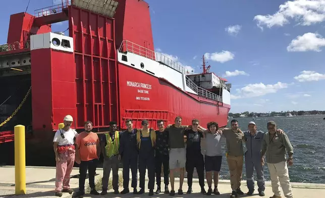 This photo provided by Ievgen Slautin of Ukraine, captain of the cargo ship Monarch Princess, shows him, second from left, with the six men who were with him on the ship abandoned by owners Teeters Agency &amp; Stevedoring at the Port of Palm Beach in Riviera Beach, Fla., and other men in 2023. Left hanging by Teeters were the ships' crews of mostly Ukrainian seafarers, who suddenly had no way of sending money to families back home in what was now a war zone after Russia’s invasion. (Courtesy Ievgen Slautin via AP)