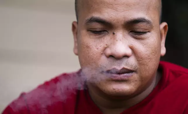 Seafarer Richard Zambales, from the Philippines, smokes outside a temporary rental house in Lacey, Wash., on Tuesday, Jan. 30, 2024. While waiting for backpay, stuck in the U.S., Zambales wasn’t sure he would be able to pay for his wife’s heart medication. (AP Photo/Lindsey Wasson)