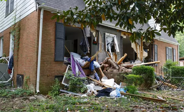 Debris surrounds a home, Tuesday, April 30, 2024, where a shootout between a suspect and officers occurred on Monday, in Charlotte, N.C. Police say a shootout that killed four law enforcement officers and wounded four others began as officers approached the home to serve a warrant for a felon wanted for possessing a firearm. (AP Photo/Nell Redmond)