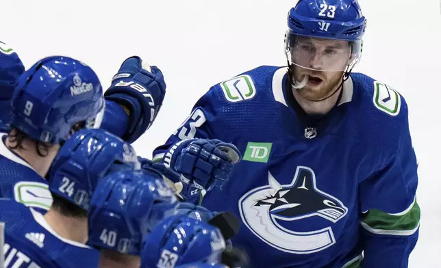 Vancouver Canucks' Elias Lindholm is congratulated for his goal against the Edmonton Oilers during the second period of Game 1 of a second-round NHL hockey Stanley Cup playoffs series, Wednesday, May 8, 2024, in Vancouver, British Columbia. (Ethan Cairns/The Canadian Press via AP)