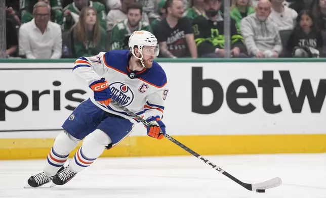 Edmonton Oilers center Connor McDavid controls the puck during the first period in Game 2 of the team's Western Conference finals against the Dallas Stars in the NHL hockey Stanley Cup playoffs Saturday, May 25, 2024, in Dallas. (AP Photo/Tony Gutierrez)