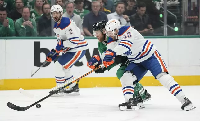 Edmonton Oilers left wing Zach Hyman (18) and Dallas Stars center Joe Pavelski (16) compete for control of the puck during the first period of Game 1 of the Western Conference finals in the NHL hockey Stanley Cup playoffs Thursday, May 23, 2024, in Dallas. (AP Photo/Tony Gutierrez)